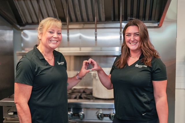 Mary-Jane and Meghan making a heart with their hands